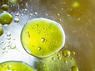 Abstract oil bubbles in water with a touch of green