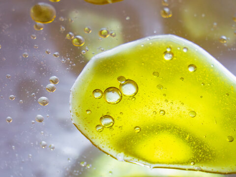 Close-up of oil and water mixture with natural elements