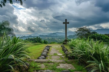 Fototapeta premium Tranquil stone path leading to a cross with dramatic clouds over a lush mountain valley