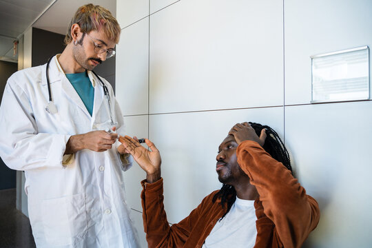 Doctor conducting blood sugar test for hypoglycemia patient