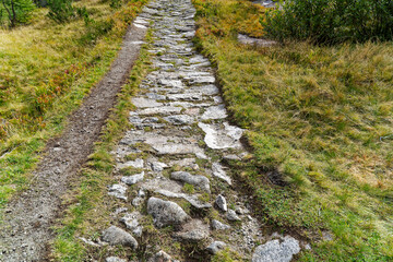 Scenic view of alpine landscape at hiking trail at Swiss mountain pass Grimsel on a cloudy late summer day. Photo taken September 19th, 2023, Grimsel, Canton Bern, Switzerland.