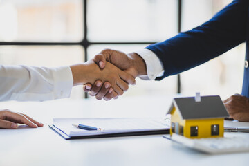 Handshake and business success, Real estate agents and customers shake hands to congratulate after signing a contract to buy a house with land and insuranc, loan, mortgage, lease.