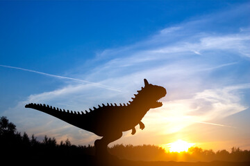 Silhouette of dinosaurs in the sunset