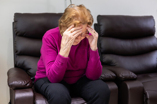 Elderly woman experiencing hypoglycemic symptoms at home