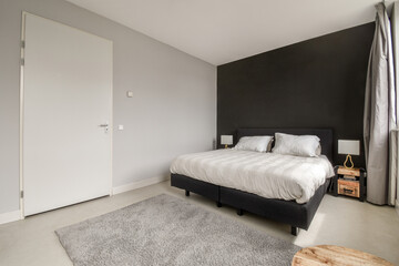 Modern bedroom interior with elegant dark accent wall