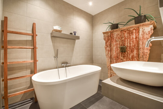 Modern bathroom with vintage wooden vanity and plants
