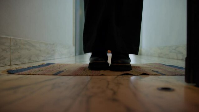 Girl Enters The House And Cleans Her Shoes On The Doormat