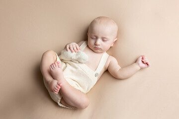 a small child lies on a light background. newborn boy. baby's first photo shoot