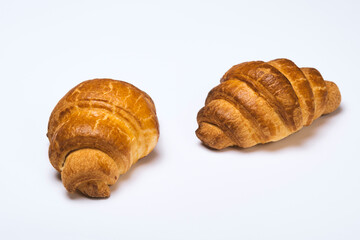 two fresh croissants on white background