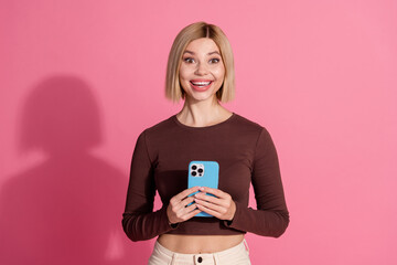 Photo of positive nice lovely girl wear stylish brown clothes use apple iphone isolated on pink...