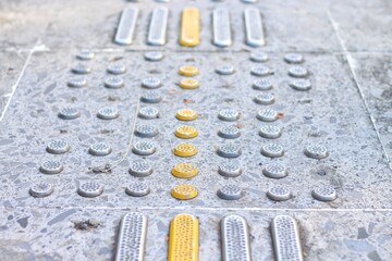 Pedestrian paths, Braille blocks in tactile paving for the blind handicapped in tiled pathways,...