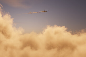 airplane with contrails flying over clouds. 3D Rendering