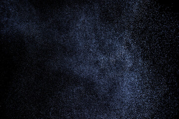 Black and blue grunge texture. Abstract splashes of water on dark background. Light clouds overlay texture on black backdrop.	