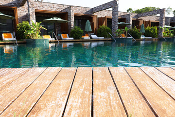 Wooden deck, swimming pool and recreational area at luxury resort