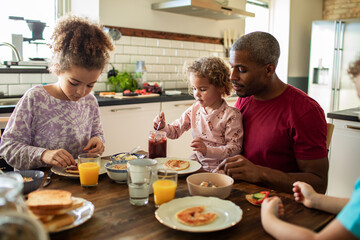 Father having breakfast with children at home