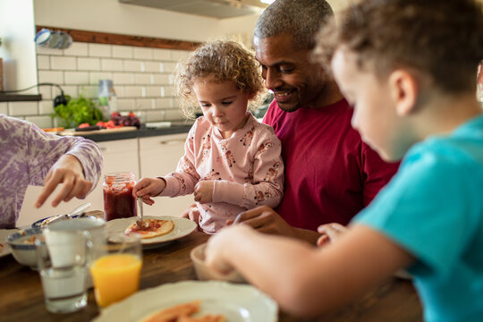 Father having breakfast with children at home