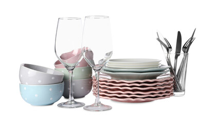 Set of beautiful ceramic dishware, glasses and cutlery isolated on white