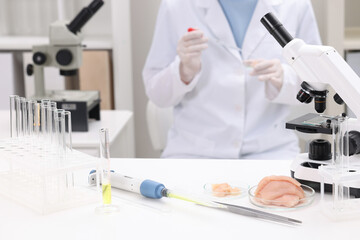 Quality control. Food inspector examining meat in laboratory, closeup