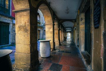 Typical medieval street of Aviles with arcades, the Ferreria street. Asturias , Spain