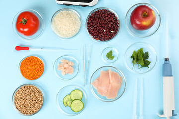 Food quality control. Petri dishes with different products, pipettes and tweezers on light blue...