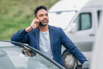 businessman with car and mobile phone