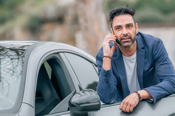 businessman with car and mobile phone