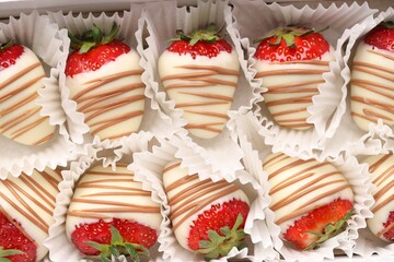 Delicious chocolate covered strawberries in box, top view