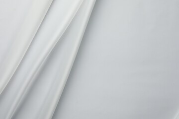 Texture of crumpled white silk fabric as background, top view. Space for text