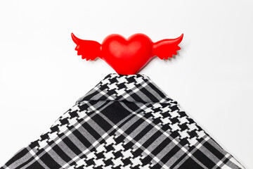 Traditional Middle Eastern and Arabic head scarf keffiyeh. The other name is puşhi, hijab' with winged red heart on a white background.