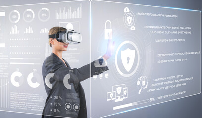 Business woman pointing and accessing at security protection system while using visual reality...
