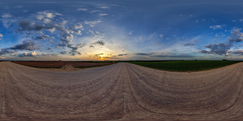 hdri 360 panorama on gravel road among fields in spring nasty evening before sunset in equirectangular full seamless spherical projection, for VR AR virtual reality content