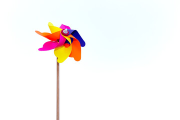 Colorful windmills on isolated white background in selective focus. Windmills with wings of...