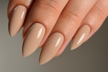Close-up image of a hand showcasing a professional manicure with glossy, neutral tone, long almond-shaped nails. Ideal for beauty, fashion, and nail care concepts
