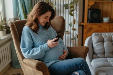 Obraz premium Radiant pregnant woman sits comfortably in a chair, caressing her belly with a gentle smile as she engages with her smartphone, surrounded by the warmth of her cozy living space