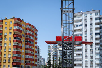 Carrying furniture up and down lift. Transporting household goods by elevator to high-rise buildings by mobile vehicle. Cargo, moving, changing house, moving goods, lift carrying idea. © CONQUEROR