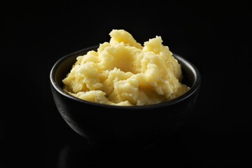 Deliciously rich bowl of mashed potatoes topped with freshly-cracked black pepper