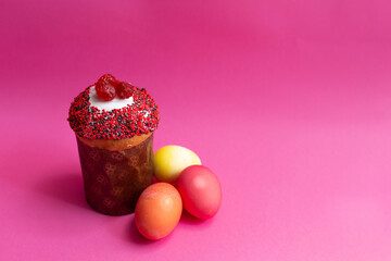 homemade cake and colored eggs on a pink background. bright holiday of Easter