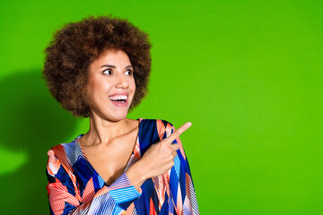 Photo of glad surprised woman wear trendy clothes look empty space news isolated on green color...