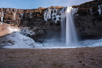 Snowy waterfall with ice