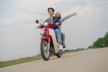 Joyful couple on motorcycle adventure
