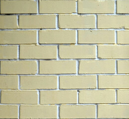 Yellow bricks wall as background front view close up real photo