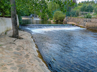 Water flowing through weir from the spring at Olhos d'Água beach, Alcanena PORTUGAL