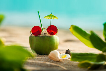Beach vacation background, Fresh tender coconut juice with sunglass on tropical beach