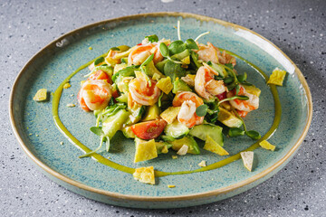 delicious fresh salad with shrimp and avocado on a beautiful plate
