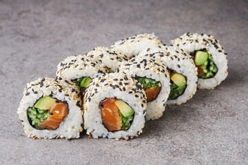 delicious fresh sushi roll with salmon cucumber and avocado