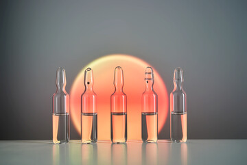 Ampoules for injection against the background of a bright orange circle.