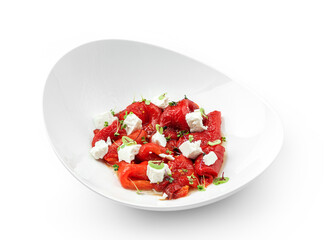 Baked roasted red pepper with feta cheese on plate isolated on white background. Healthy food, vegan salad, close up, top view