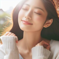 An Asian woman enjoying the gentle warmth of the sun.