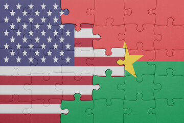 puzzle with the colourful national flag of burkina faso and flag of united states of america .