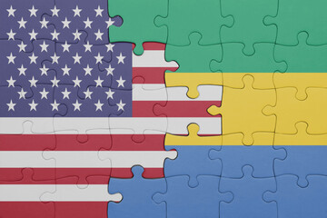 puzzle with the colourful national flag of gabon and flag of united states of america .